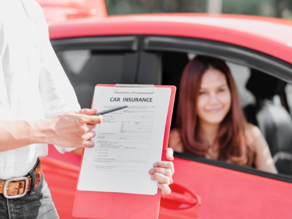 Man Showing a Car Insurance Form