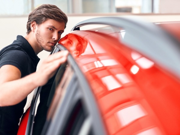 Man Inspecting a Car