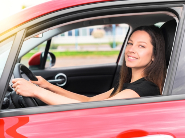 Woman Driving a Red Car