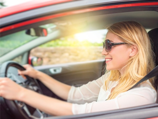 Woman Driving a Red Car
